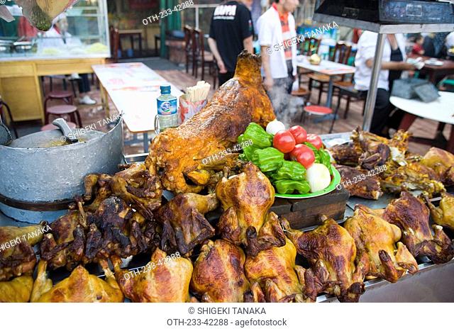 Roast chicken and lamb displaying in a food stall in the night market of Erdaoqiao, Wulumuqi, Xinjiang Uyghur autonomy district, Silk Road, China
