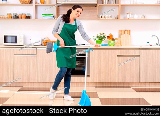 Young female contractor doing housework