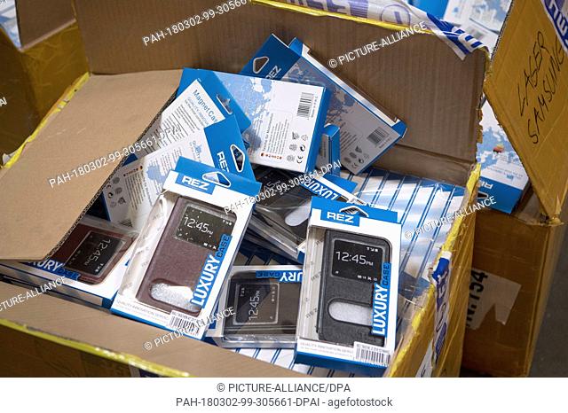 28 February 2018, Germany, Frankfurt: German customs seized fake phone cases at a secret shipping's storage at an industrial estate