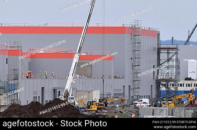 12 October 2021, Thuringia, Ichtershausen: Builders are working on the construction of a large battery cell factory for electric cars
