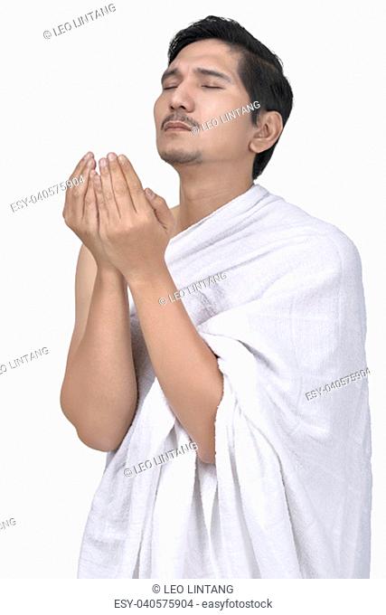 Religious asian muslim man with hajj cloth pray isolated over white background