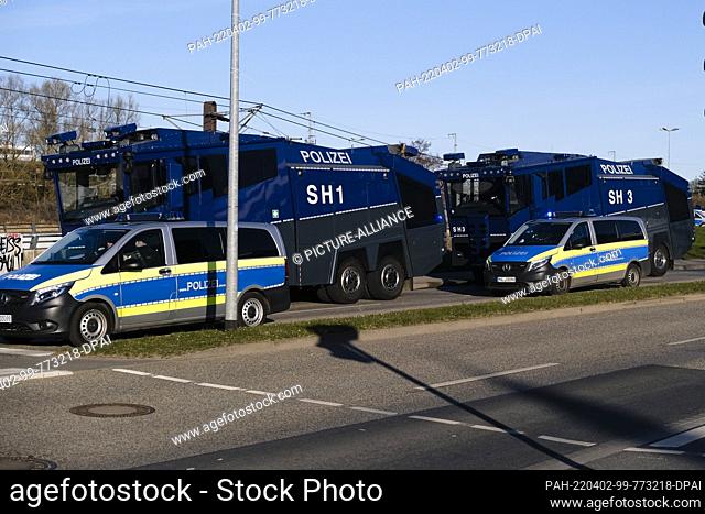 02 April 2022, Mecklenburg-Western Pomerania, Rostock: Police emergency vehicles are parked near the main train station before the match of the second division...