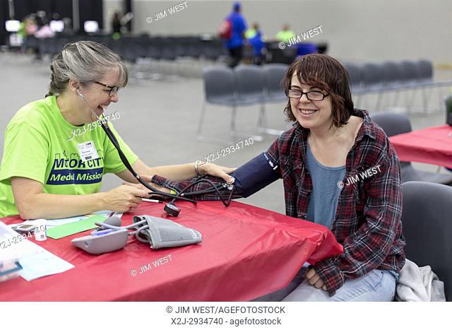 Detroit, Michigan USA - 9 August 2017 - A volunteer nurse takes the blood pressure of a patient at the Motor City Medical Mission
