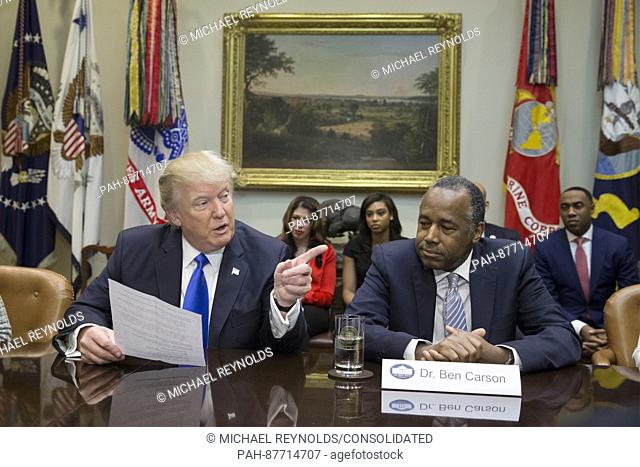United States President Donald J. Trump (L) speaks beside his nominee to lead the Department of Housing and Urban Development (HUD) Ben Carson (R)