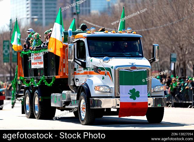Chicago, Illinois, USA - March 16, 2019: St. Patrick's Day Parade, Large truck Peterbilt with Irish flags going down columbus dr
