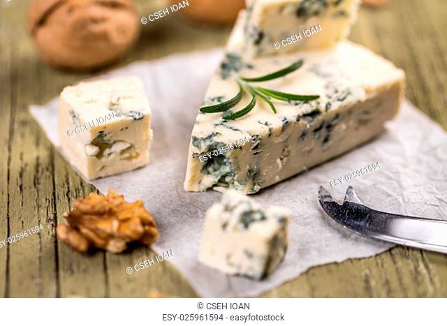 Blue cheese on wooden background