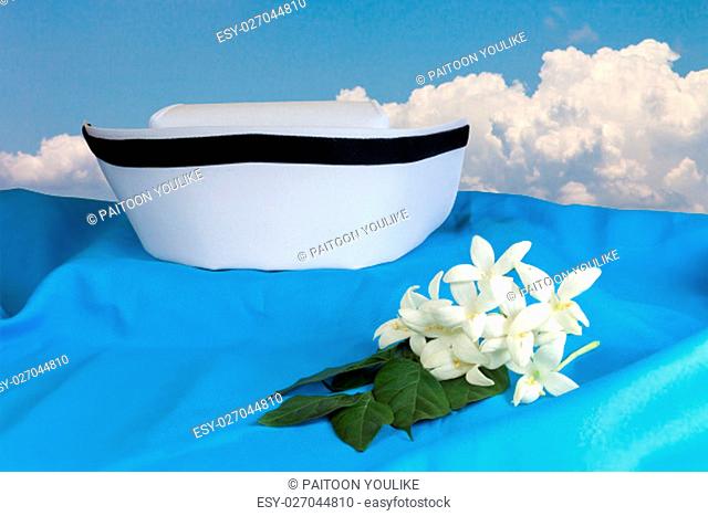 Hat nurse white and Millingtonia hortensis flowers on blue fabric. symbol of nursing thailand and Thai traditional medicine