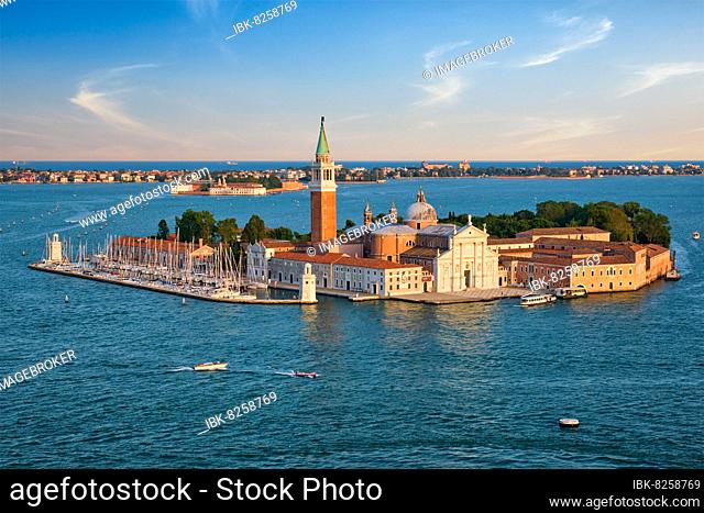 Famous Italy tourist destination, aerial view of Venice lagoon and San Giorgio di Maggiore church with boats and vaporetto traffic on sunset from St Mark's...