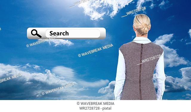Rear view of business woman looking at search bar icon against cloudy sky