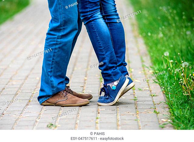 attractive couple together looking to each other kissing only legs