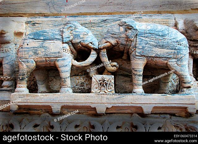 Attractive, grainy, stone statues of elephants in combat mood at Jagadeesh Temple in Udaipur, Rajasthan, India, Asia