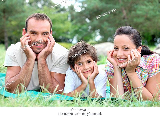 a couple and their son in the park