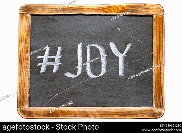 joy hashtag handwritten on vintage school slate board isolated on white