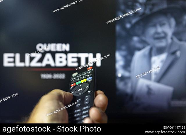 Belgrade, Serbia - September 12, 2022: Queen Elizabeth II passing. The Queen is dead at age 96. Watching news on tv about late Queen of England with remote...