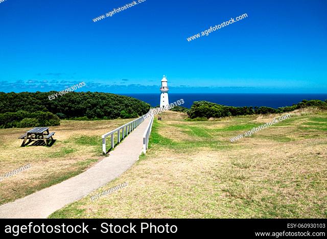 Cape Otway Lighthouse in grasslandpark with bench and overlook at the ocean at the Great Ocean Road, Victoria, Australia