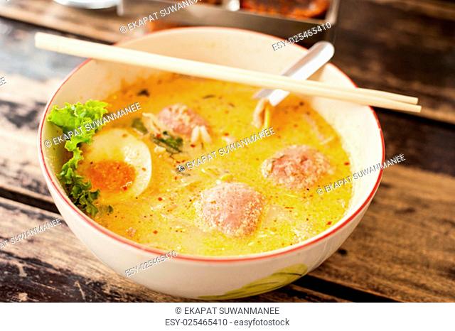 Thai food, Pork noodle tom yum, Water egg on wood table