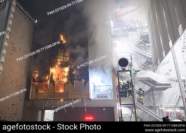 PRODUCTION - 10 October 2023, Lower Saxony, Brunswick: Firefighters extinguish a burning wooden façade during a research project at the Center for Fire Research...