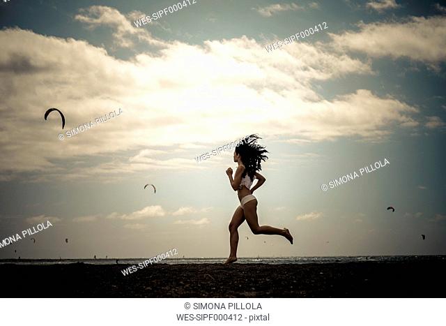 Young woman jogging on the beach