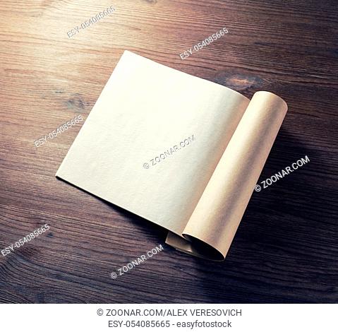 Blank opened magazine on wooden background. For design presentations and portfolios