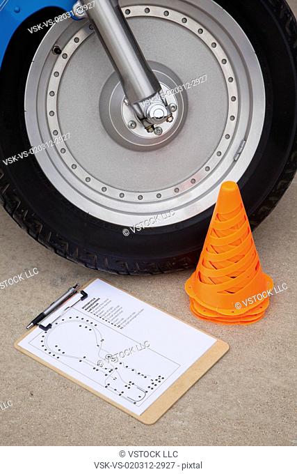 USA, Illinois, Metamora, Close up of motorcycle wheel, traffic cone and test form