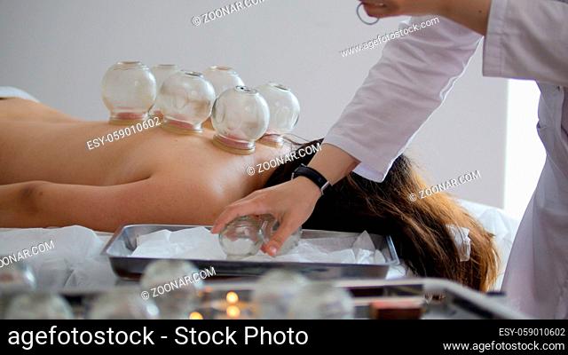 Medical glass cups in the massage room on the background of physiotherapy, Tibetan medicine