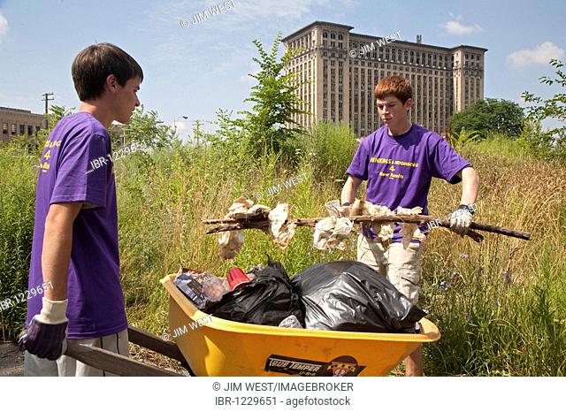 High school aged volunteers from St. Mary of the Hills Catholic church in Rochester Hills clean trash and debris from an alley in Detroit's Corktown...