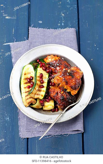 Barbecued chicken bits with grilled courgette and pomegranate seeds