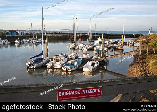 Small harbour on the Atlantic coast ( near La Rochelle, France). In the background, the Ré island bridge. In the foreground