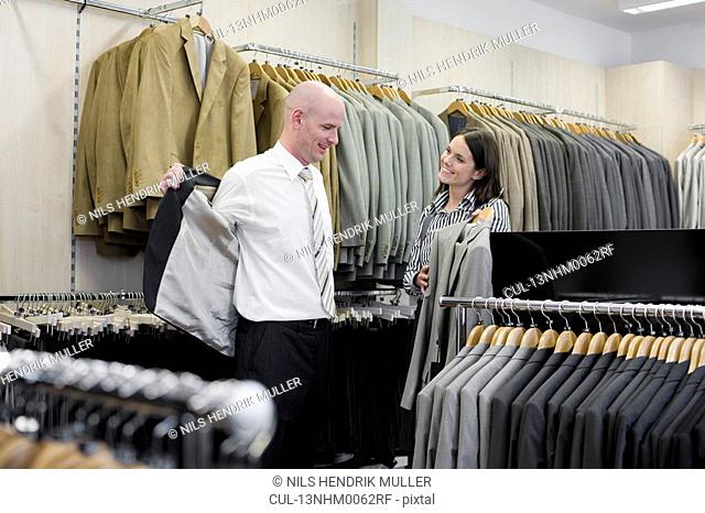 man and woman in clothing store