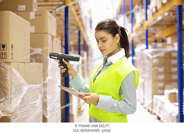 Female warehouse worker using barcode reader