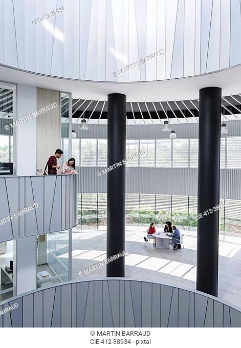 Business people meeting on architectural, modern office atrium balcony