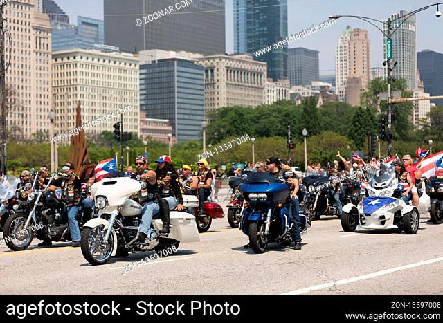 Chicago, Illinois, USA - June 16, 2018: The Puerto Rican Day Parade, Puerto rican bikers riding motorcycles with the puerto rican flag during the parade