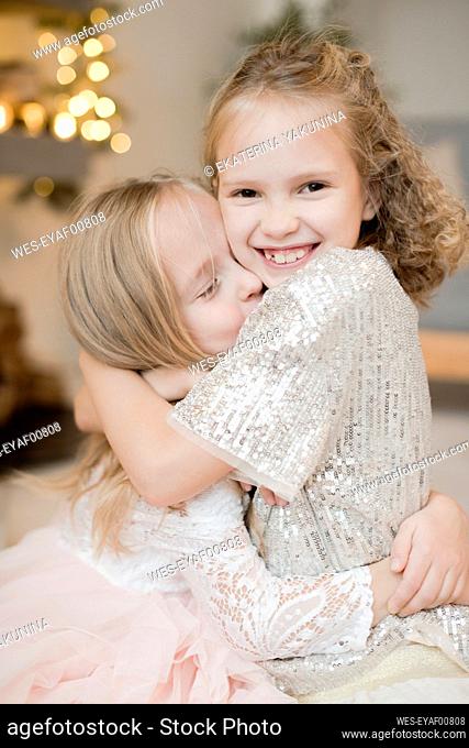 Portrait of two happy little girls huging each other