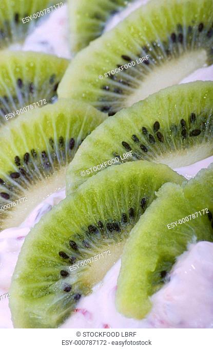 Slices of kiwi fruit and quark on bread detail