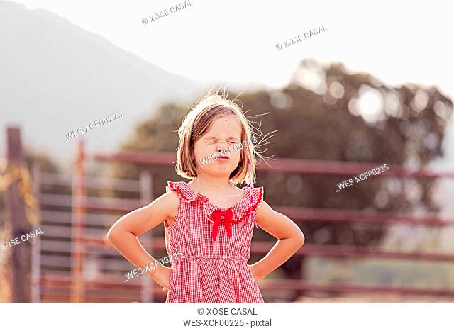 Portrait of little girl with eyes closed pouting mouth