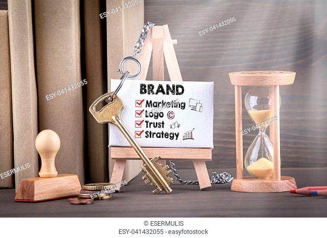 brand concept with icons. Sandglass, hourglass or egg timer on wooden table showing the last second or last minute or time out