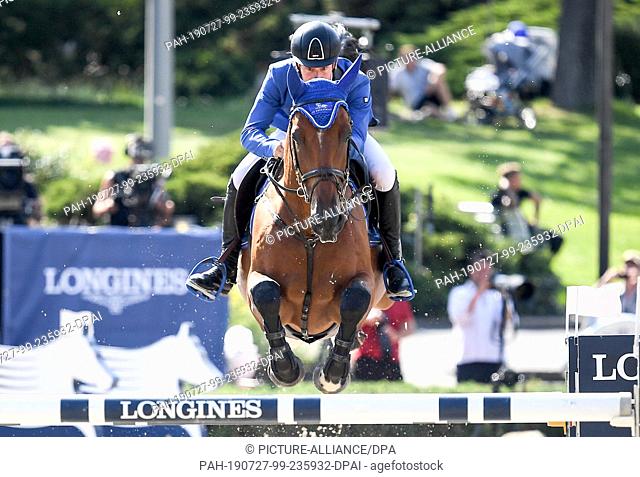 27 July 2019, Berlin: Equestrian sports/jumping: Global Champions Tour: Bart Bles from the Netherlands jumps with the horse Kriskras DV over an obstacle at the...