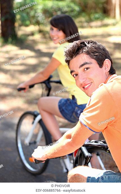 Teenage boy and girl on bike ride