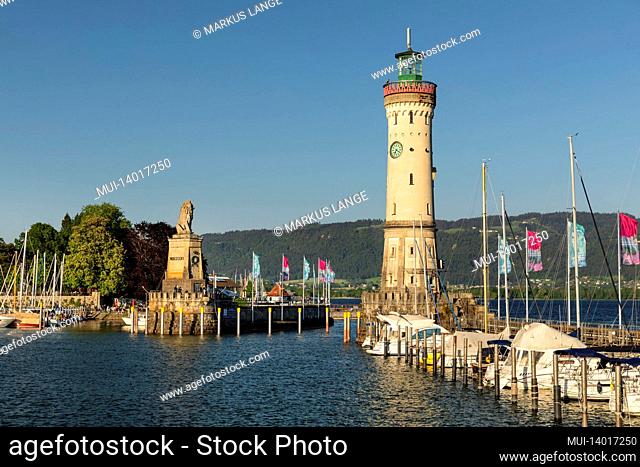 lighthouse and bavarian lion at the port entrance of lindau, lake constance, bavaria, germany