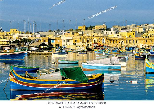 Local fishing boats or Luzzu, decorated with Osiris eyes for good luck. Marsaxlokk. Malta