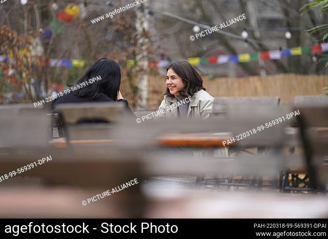 17 March 2022, Berlin: The French girls Elisa (l) and Luise met in the beer garden of the restaurant ""Schleusenkrug"". Spring-like mild temperatures are...