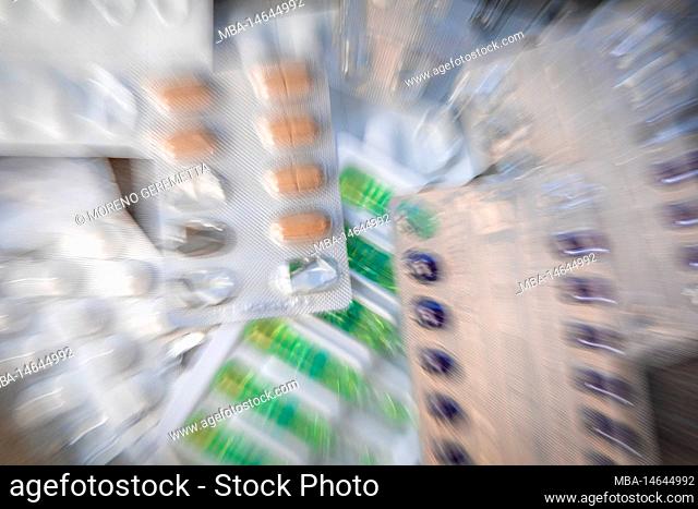 blisters of medicines, various shapes and colors, dynamic blur