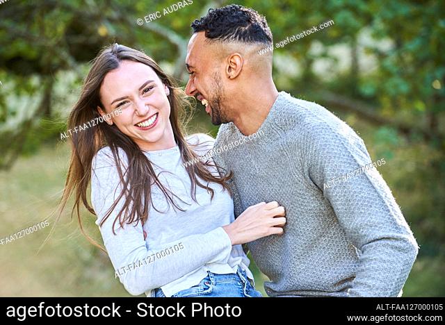 Smiling young couple in public park