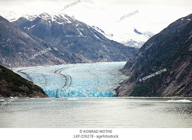 The Dawes Glacier in front of snow covered mountains, Endicott Arm, Inside Passage, Southeast Alaska, USA