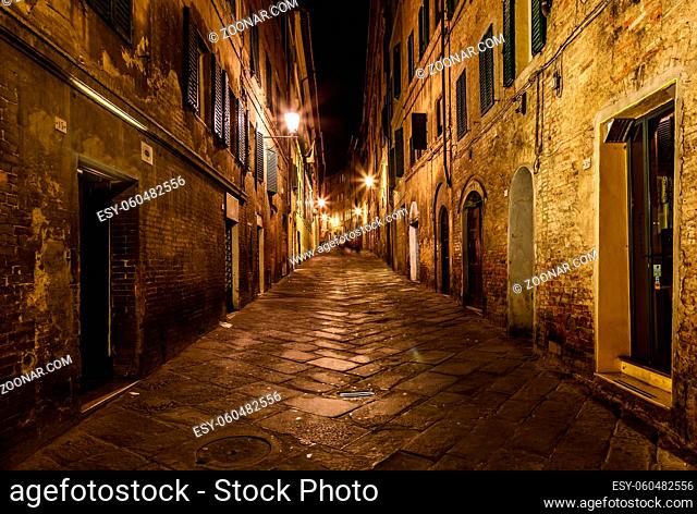 Narrow Alley With Old Buildings In Medieval Town of Siena, Tuscany, Italy