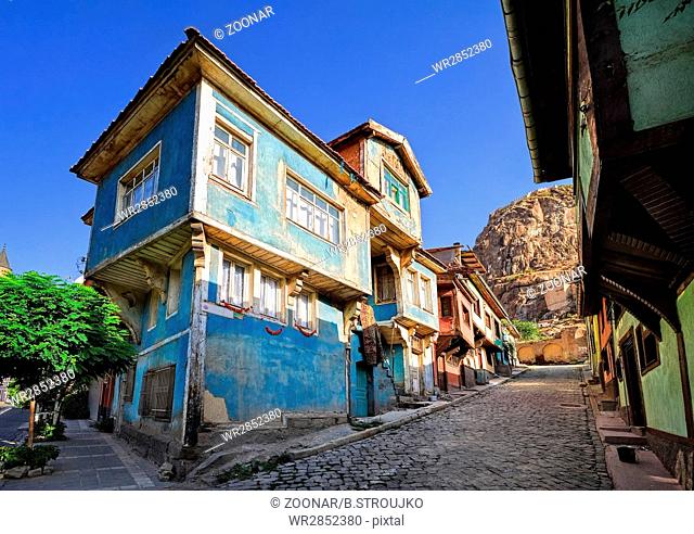 Old traditional ottoman house street with the Karahisar castle in background, Afyon, Turkey