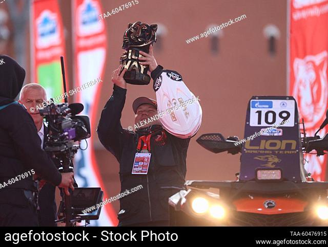 RUSSIA, MOSCOW - JULY 15, 2023: Rider Anatoly Kuznetsov (C) raises his trophy as he wins the first Enduro Quad prize during a ceremony to finish the 2023 Silk...