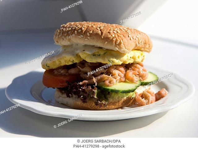 A delicious shrimp burger is being served on a plate on a ferry heading towards the German North Sea island of Borkum, Germany, 19 July 2013