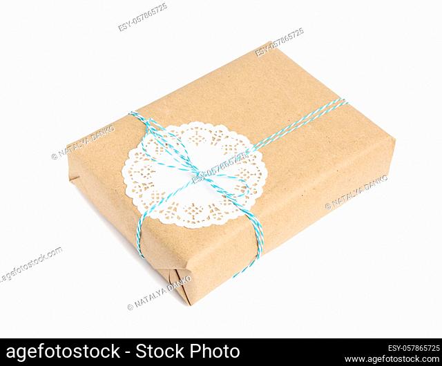box wrapped in brown kraft paper and tied with blue rope, gift isolated on white background