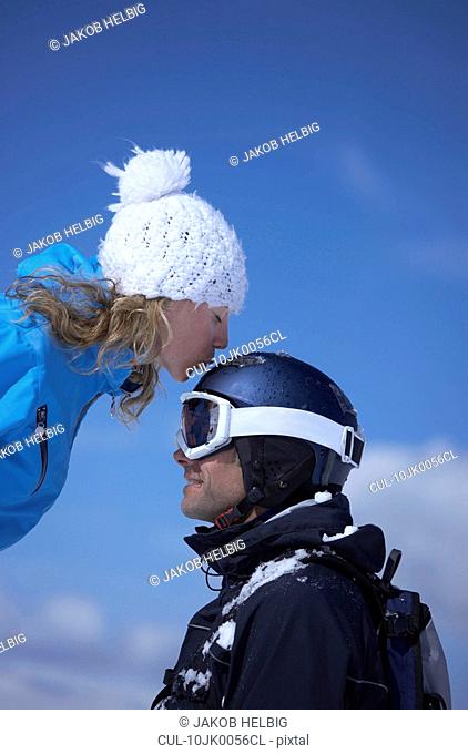 Couple sitting close in chair lift